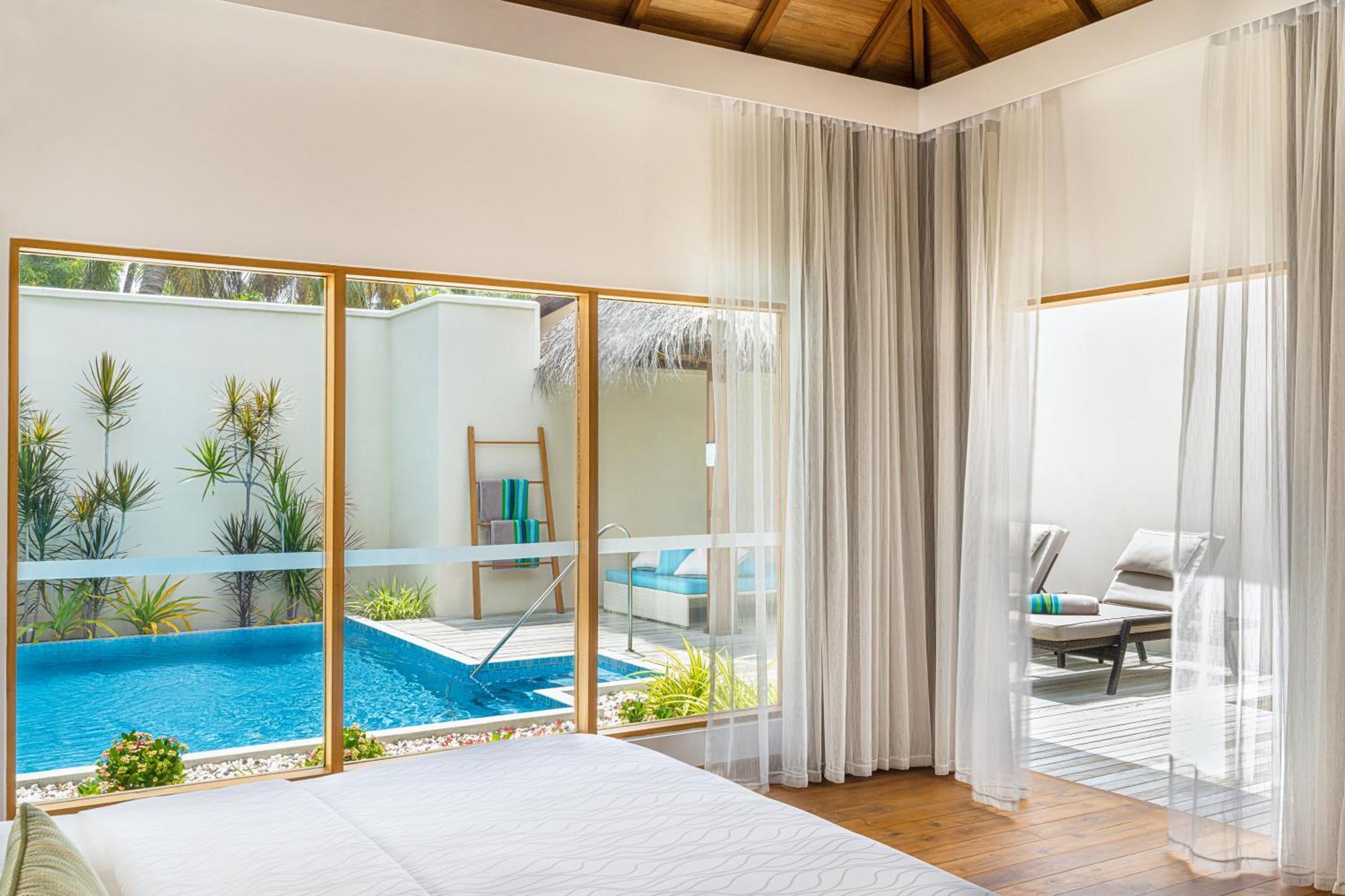 Kurumba Maldives Vihamanaafushi Buitenkant foto A bedroom at the resort